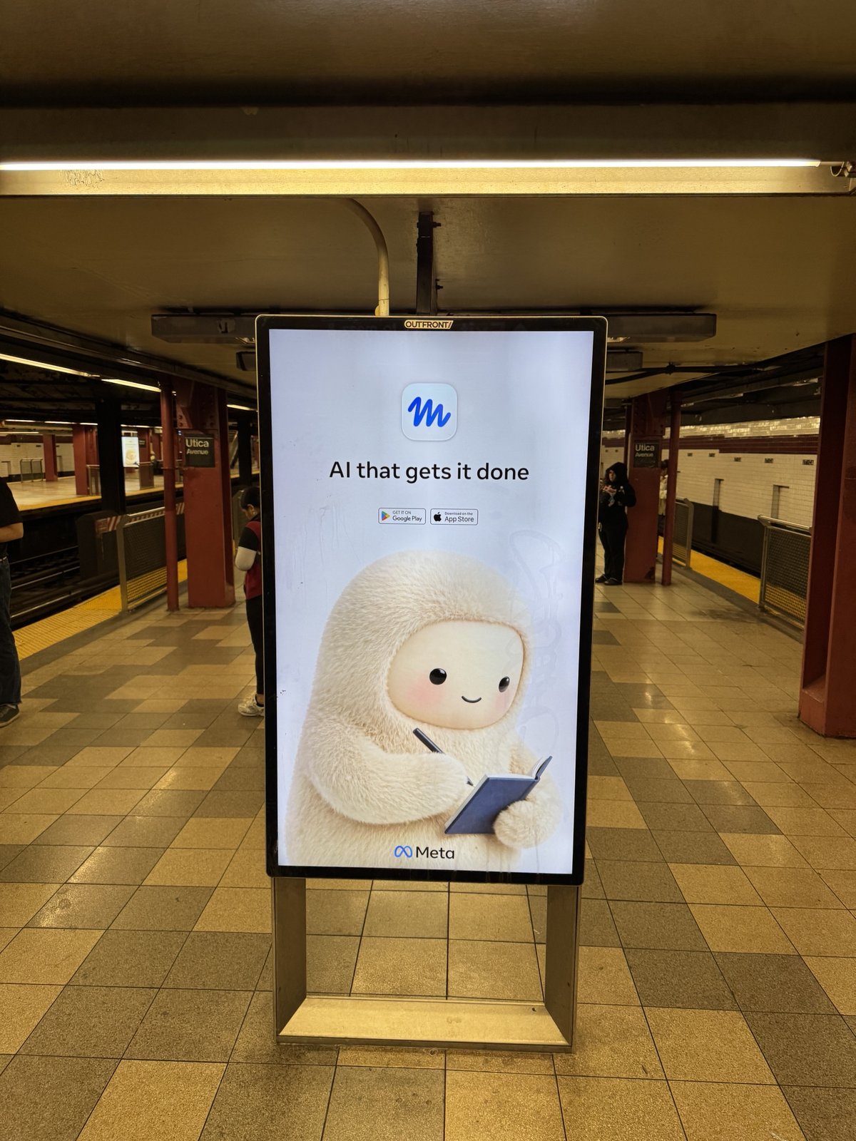 The second ad in the rotation: the same creature writing in a small notebook under the tagline "AI that gets it done."