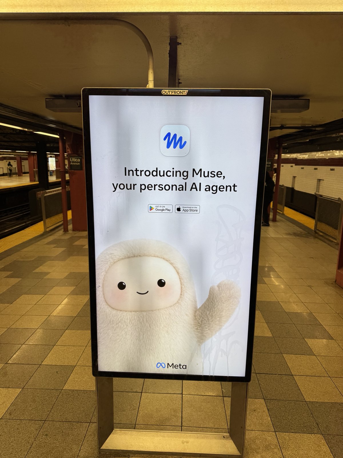 The first Muse ad on the Utica Avenue platform: a fluffy white creature with black eyes and pink cheeks waves under the words "Introducing Muse, your personal AI agent."